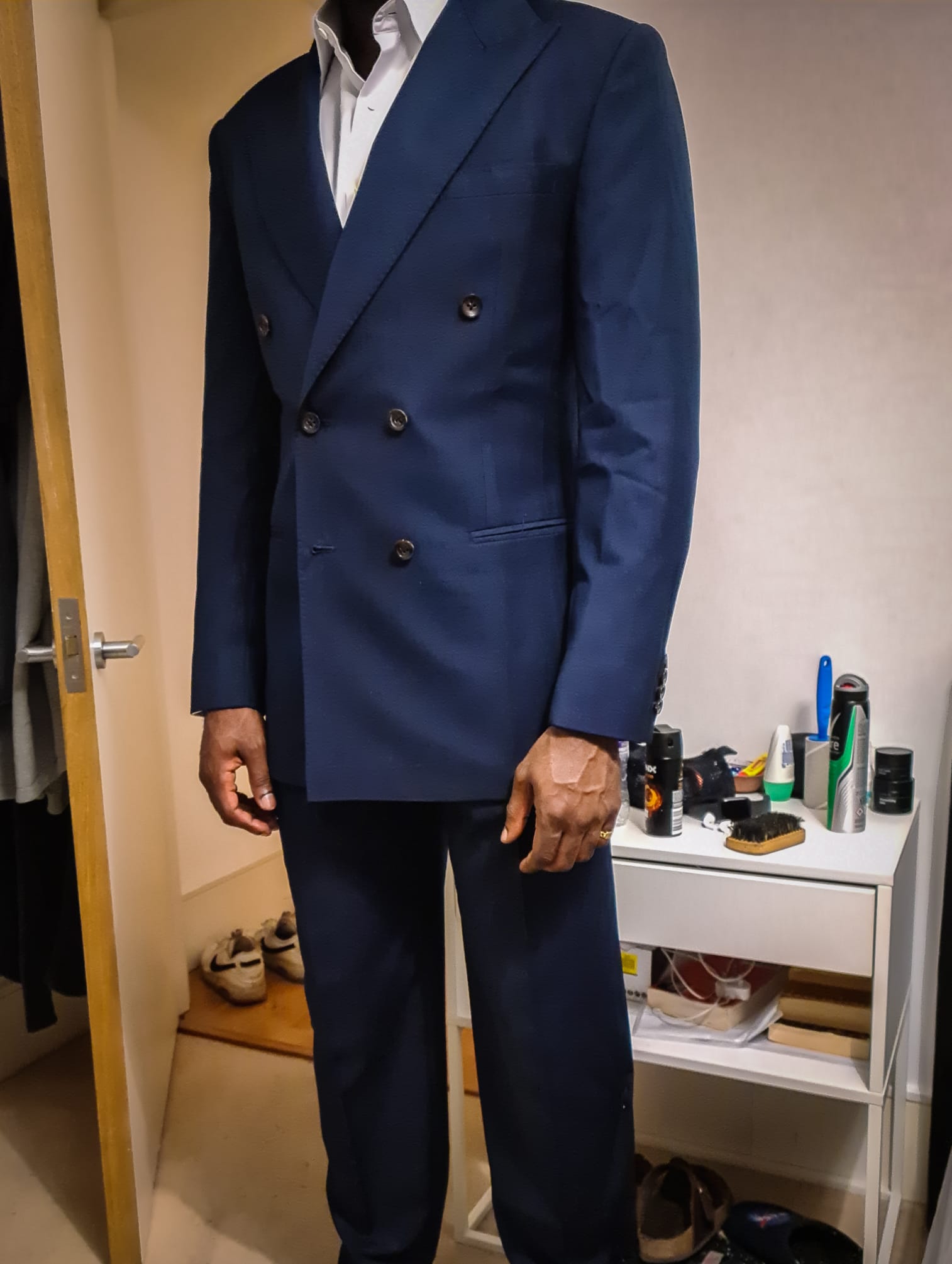 A navy suit being assessed during a private fitting