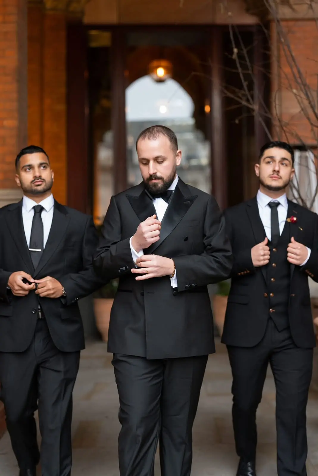 A black double-breasted dinner suit worn at a wedding